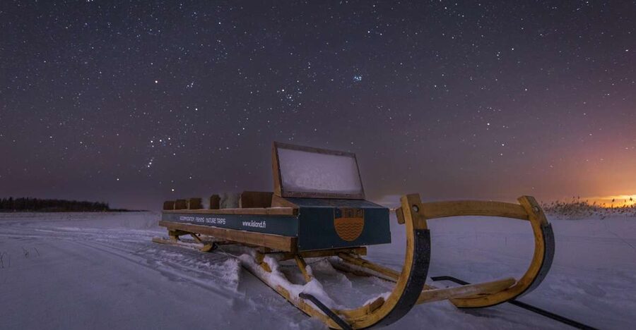 Ii: Snowmobile sleigh trip on frozen sea under starlit sky - Why the frozen sea off Ii makes the sky feel personal